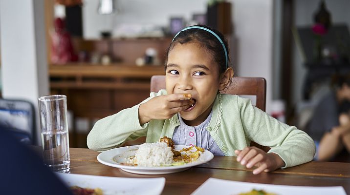 girl eating at a table